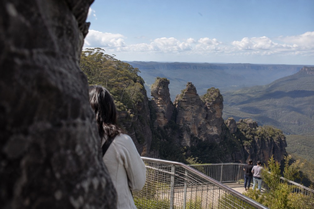 Sandstone cliffs and forested valley at Echo Point under a wide sky