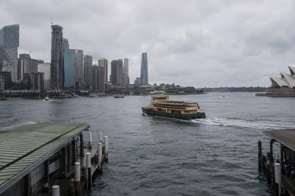 A Sydney ferry crossing the harbour with the city skyline behind it