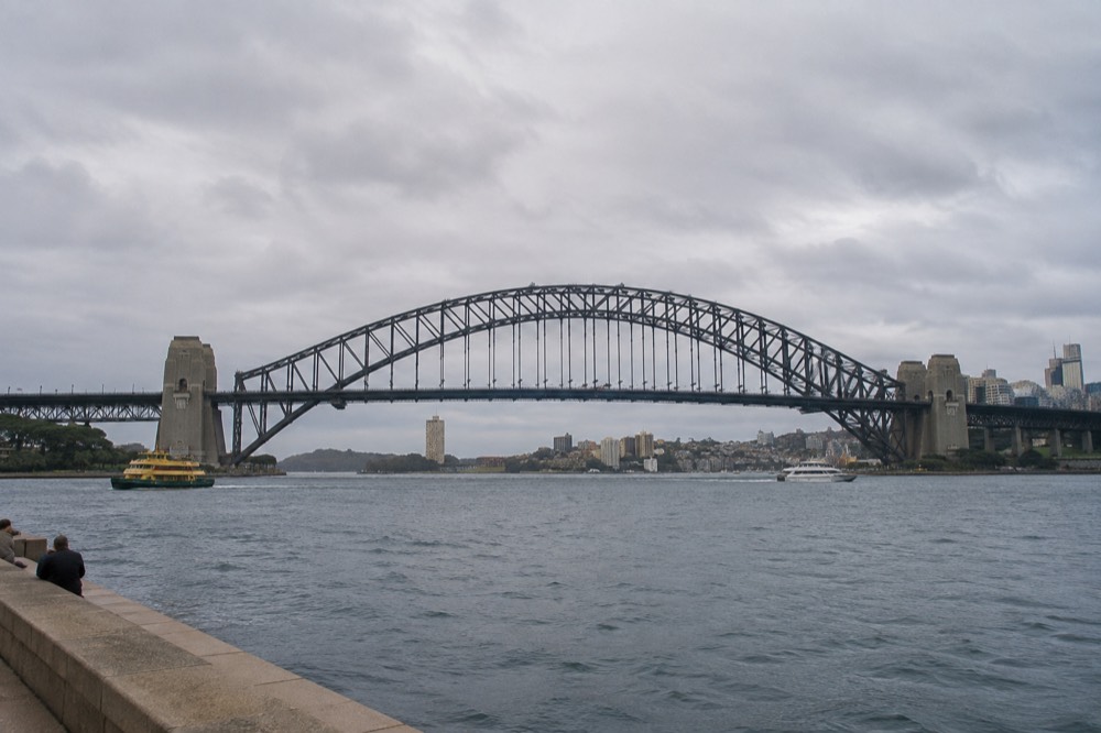 Sydney Harbour Bridge seen across the water with climbers' walkway visible on the upper arch