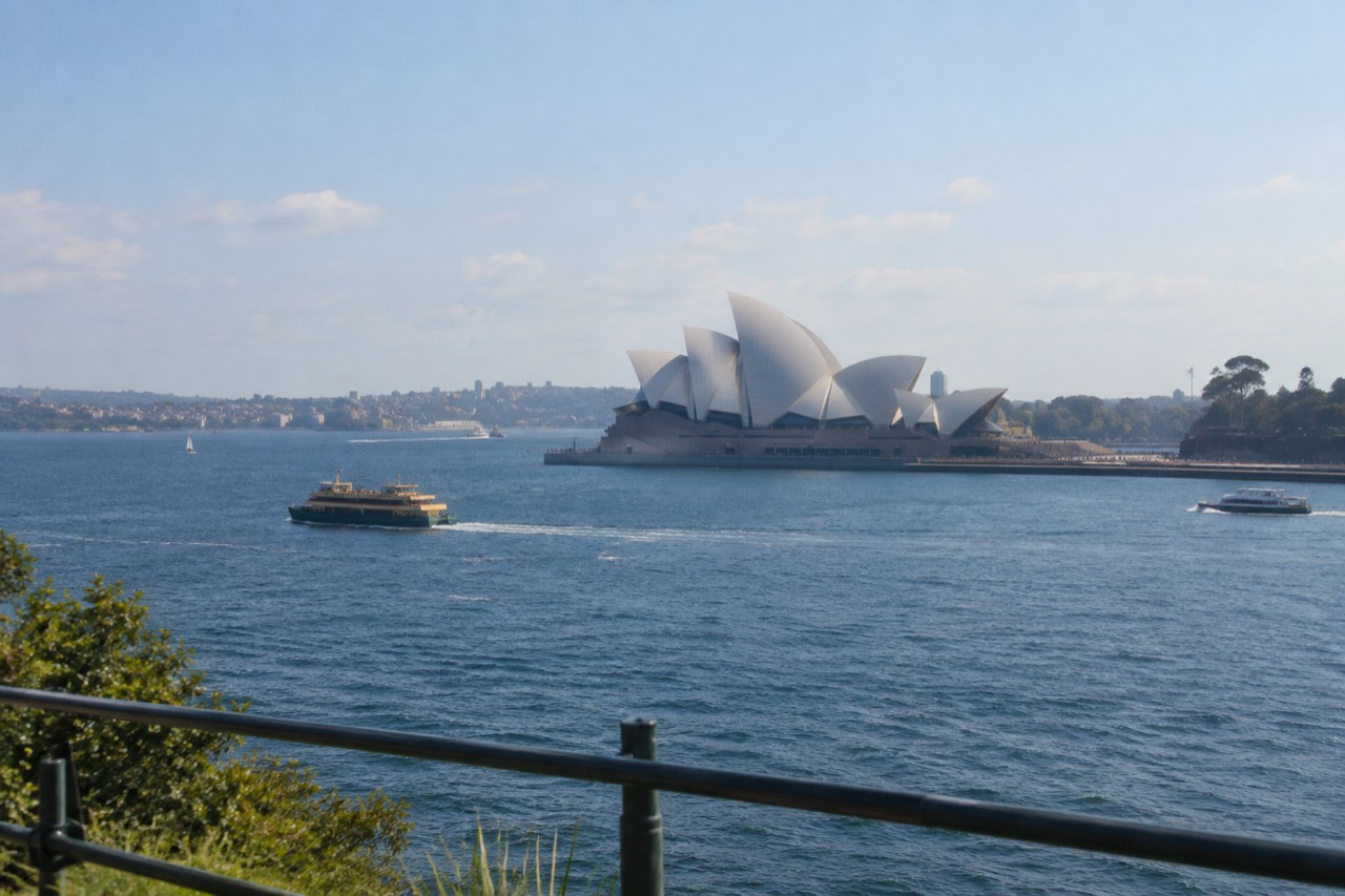 The white sails of the Sydney Opera House seen across Circular Quay on a clear morning