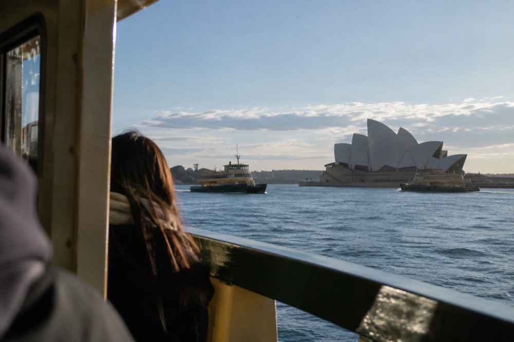 The Sydney Opera House seen from Circular Quay with ferries on the harbour