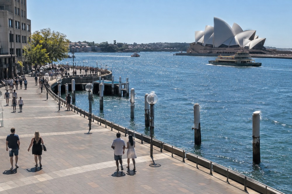 A wide harbourside promenade in Sydney with the Opera House in the distance across the water