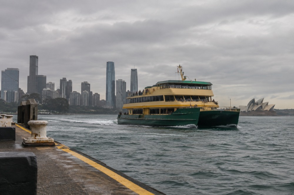 A Sydney ferry crossing the harbour with the city skyline behind it