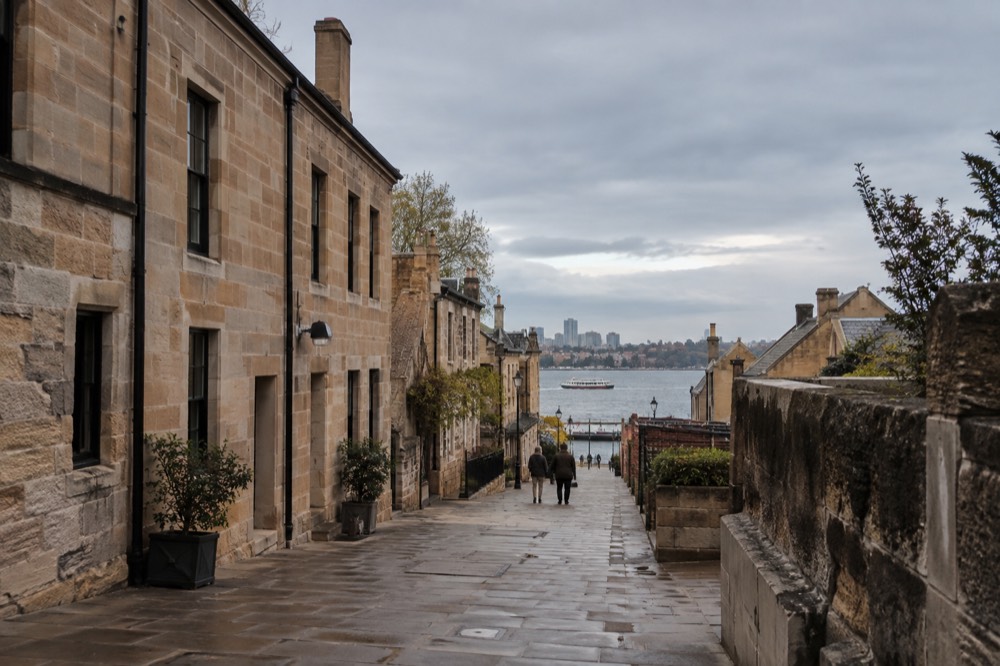 Sandstone laneway in The Rocks with heritage buildings in late afternoon light