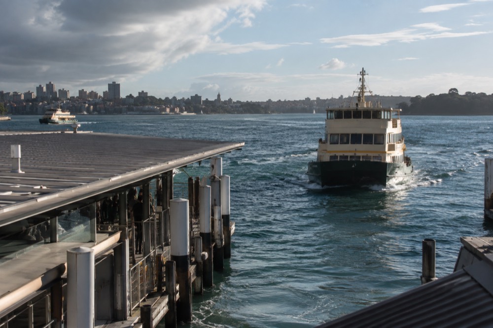 A Sydney ferry approaching a wharf near the city centre