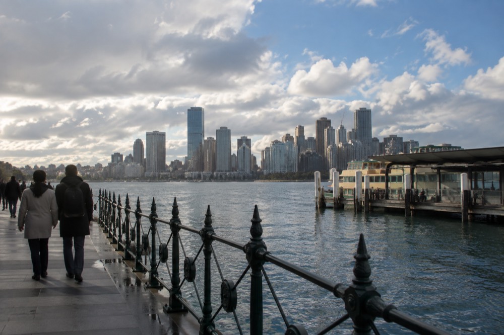 Harbour foreshore path with city skyline across the water