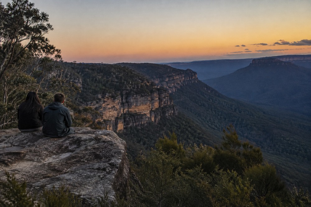 Sandstone cliffs and eucalyptus forest in the Blue Mountains under a clear sky