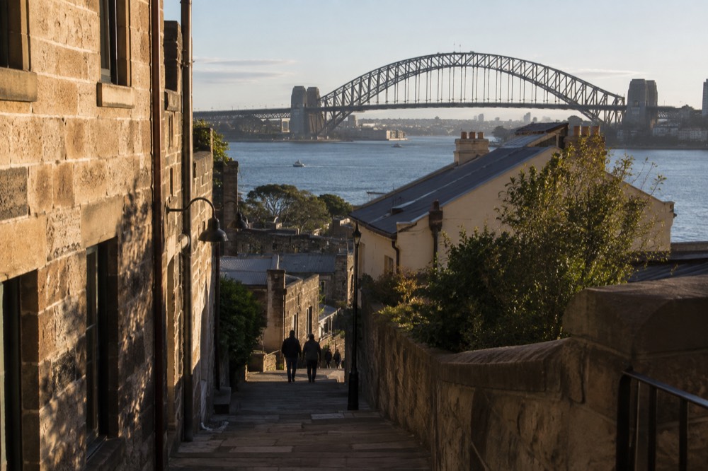 Sandstone laneway in The Rocks with the harbour bridge overhead
