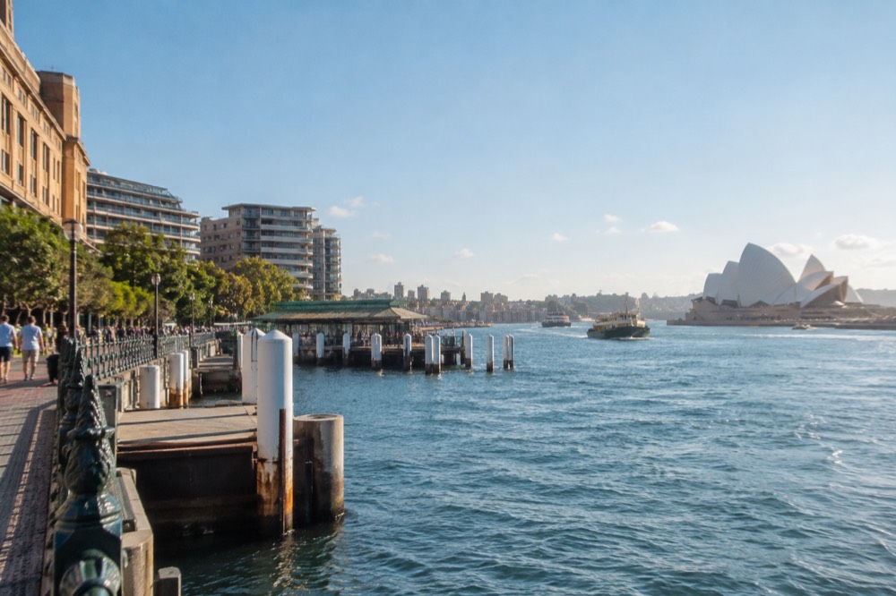 Bright morning light on the sandstone buildings of Circular Quay under a clear blue sky