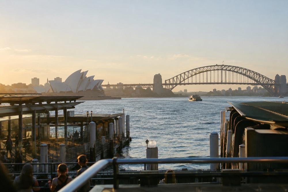 Golden late afternoon light across the rooftops and harbour of central Sydney