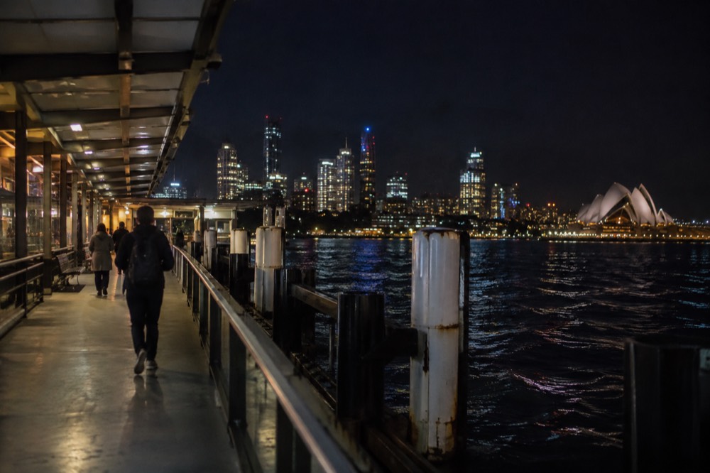 Sydney city skyline and harbour lights seen from the water at night