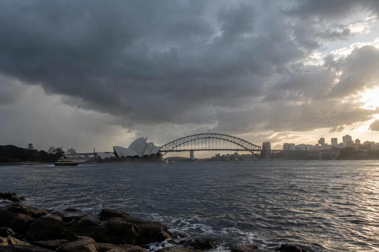 Rain clouds over Sydney Harbour with the Opera House and Harbour Bridge in view
