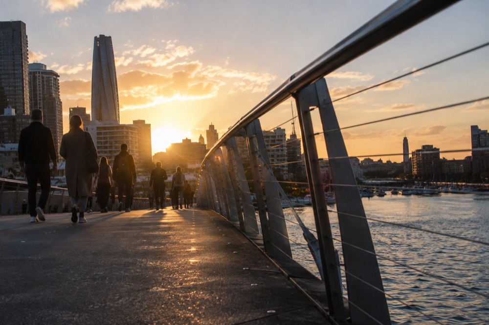 Pedestrian bridge over water linking Darling Harbour to the city side at dusk