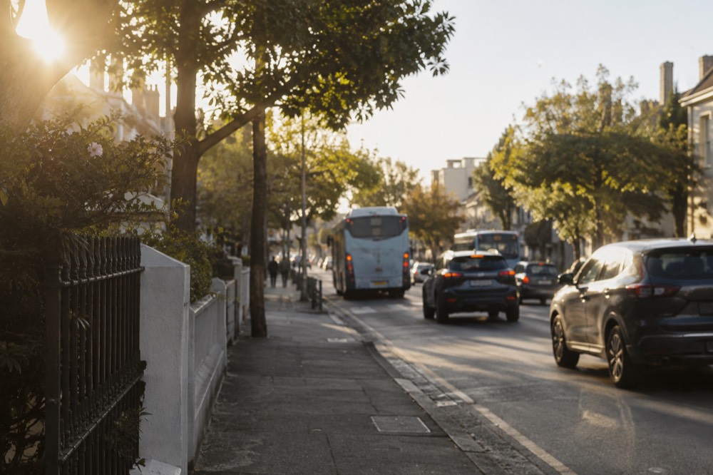 Buses and traffic moving along Oxford Street in daylight