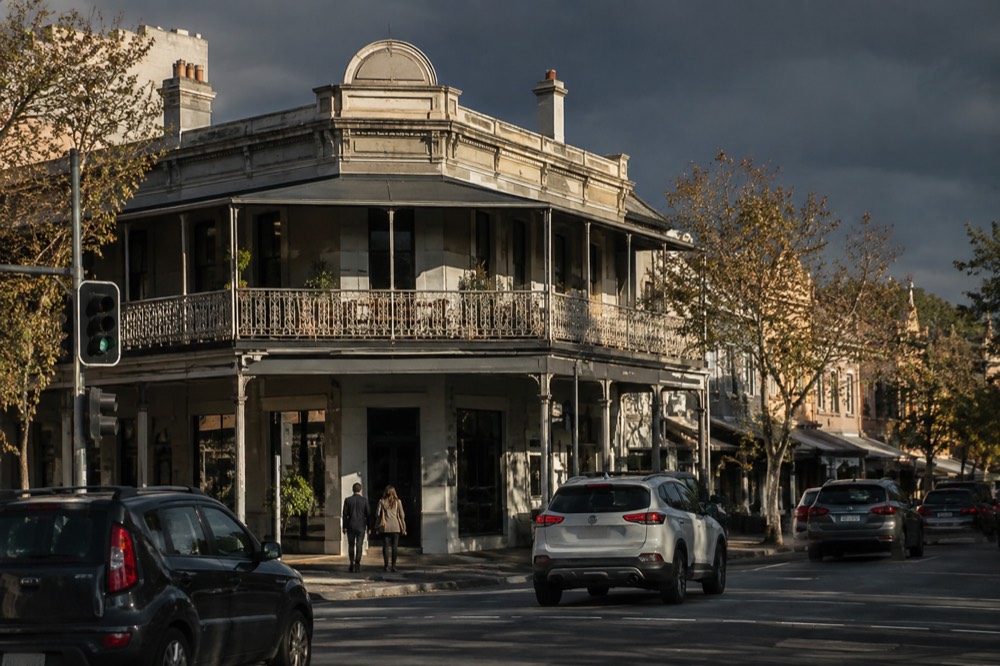 An old corner hotel building with a first-floor verandah above a shopfront
