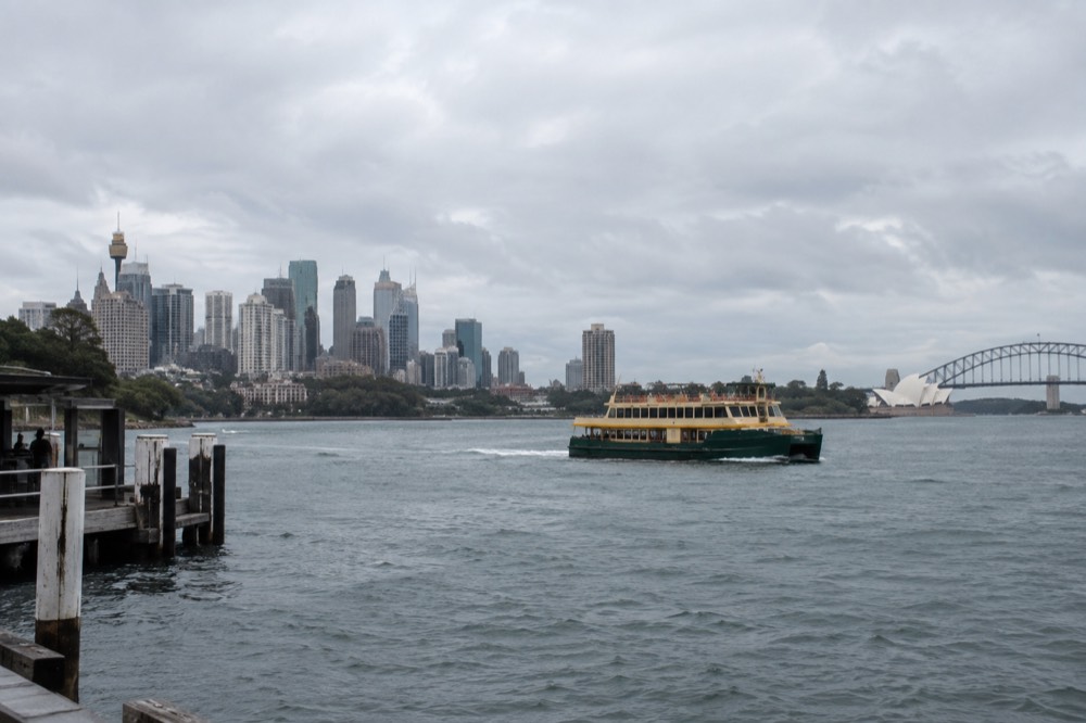Ferry on Sydney Harbour seen from Elizabeth Bay with city skyline behind