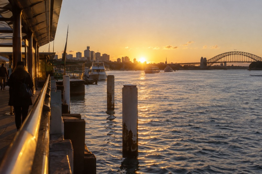 Golden evening light over the harbour water with moored yachts