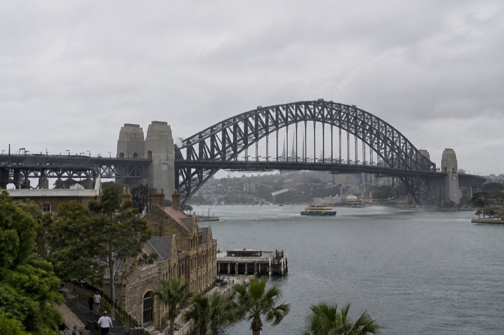 The southern approach of the Sydney Harbour Bridge seen from The Rocks, with climbers visible on the upper arch