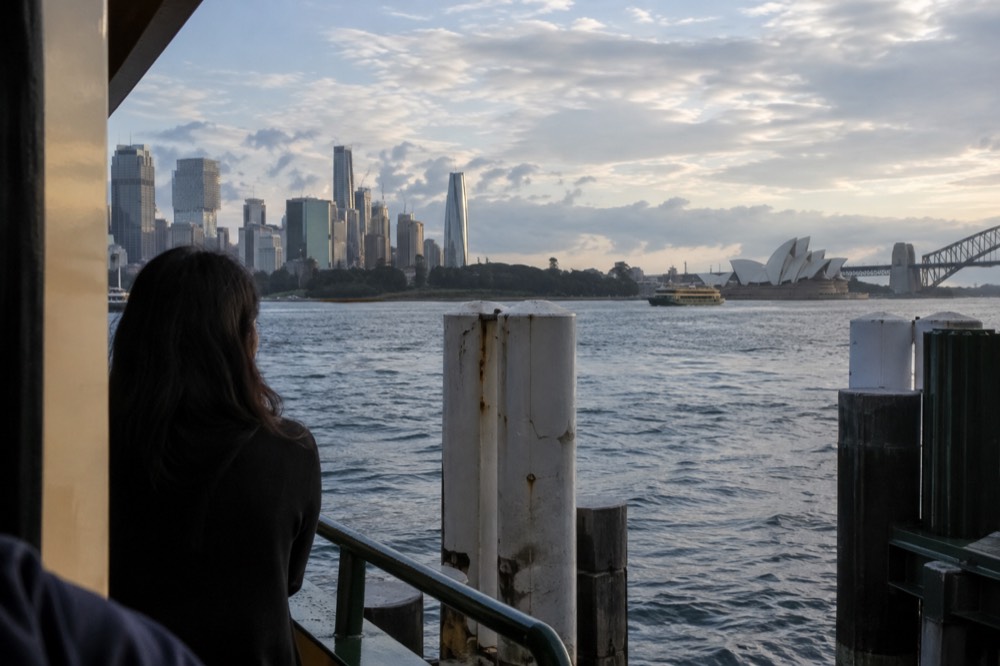 View across Sydney Harbour water from the island toward the city skyline in the distance