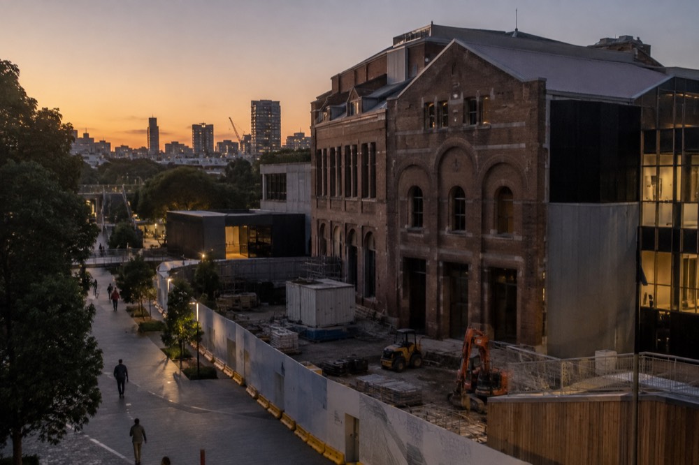 Construction hoardings surrounding a large heritage museum building in inner Sydney