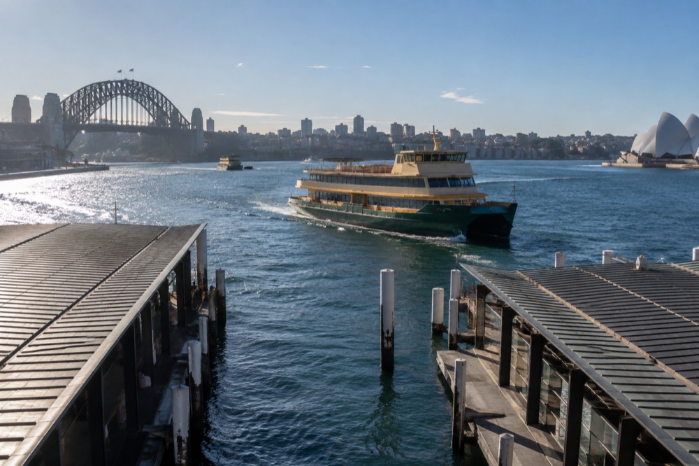 Ferry on Sydney Harbour with the city skyline behind it on a clear morning