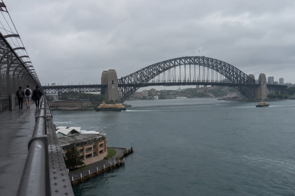 The bridge pedestrian walkway on the eastern side with harbour water and ferries visible below