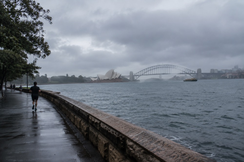 Panoramic view over Sydney Harbour with the opera house and bridge visible in the distance