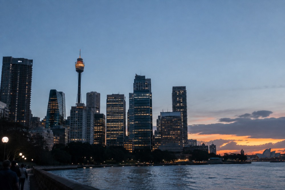 Sunset light falling across the Sydney city skyline from a high vantage point