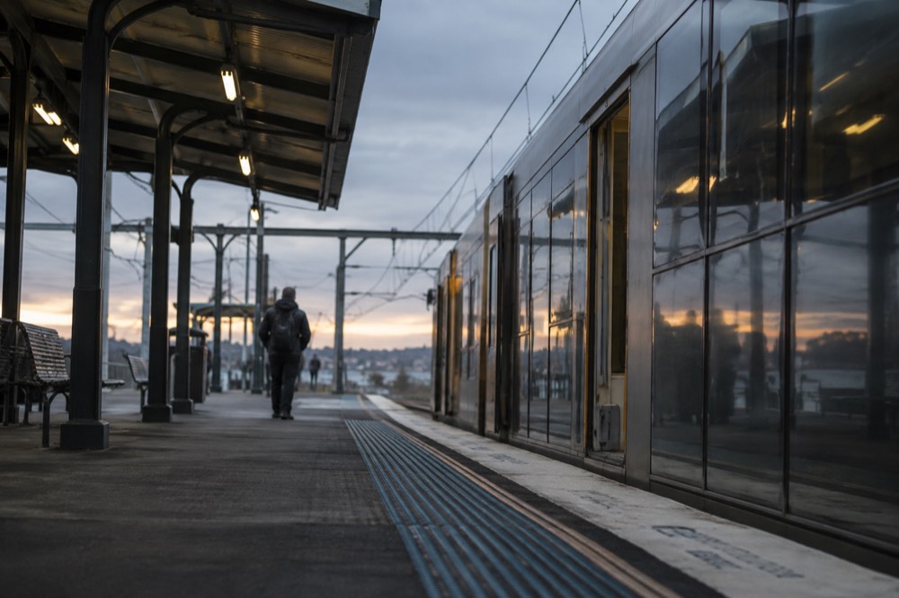 Railway platform at a Sydney intercity station with a train waiting at dawn