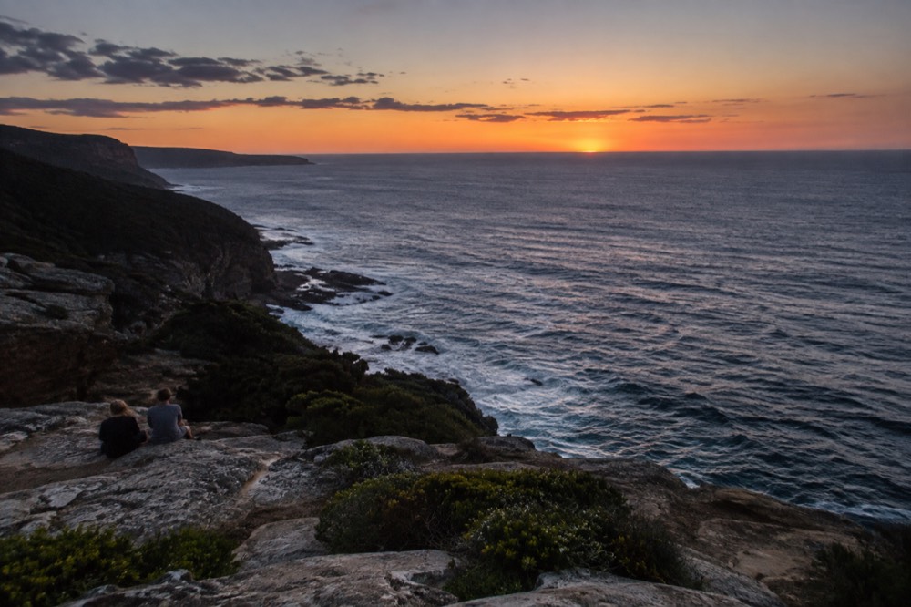 Ocean horizon seen from a sandstone clifftop at dusk