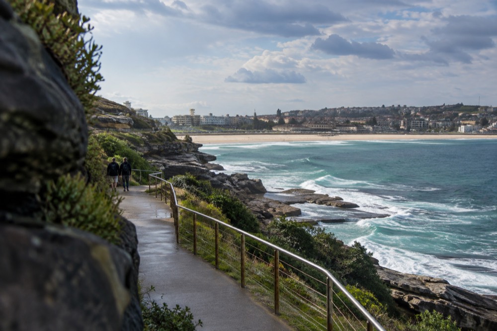 Waverley cliff tops above Bondi Beach with green ocean water and an empty coastal path
