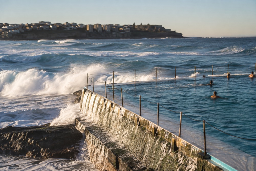 Bondi Icebergs ocean pool at the southern end of Bondi Beach with waves breaking over its edge