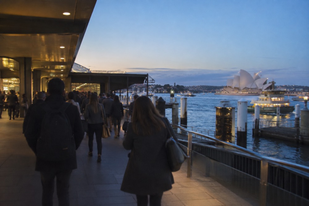 Commuters walking through a busy Sydney train station concourse