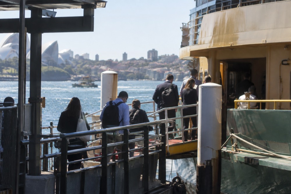 Commuters boarding a Sydney ferry at a Circular Quay wharf