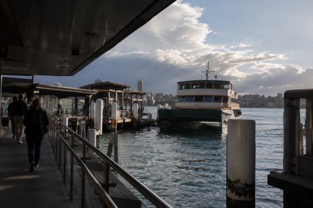 Sydney train platform with a metro train arriving at an inner-city station