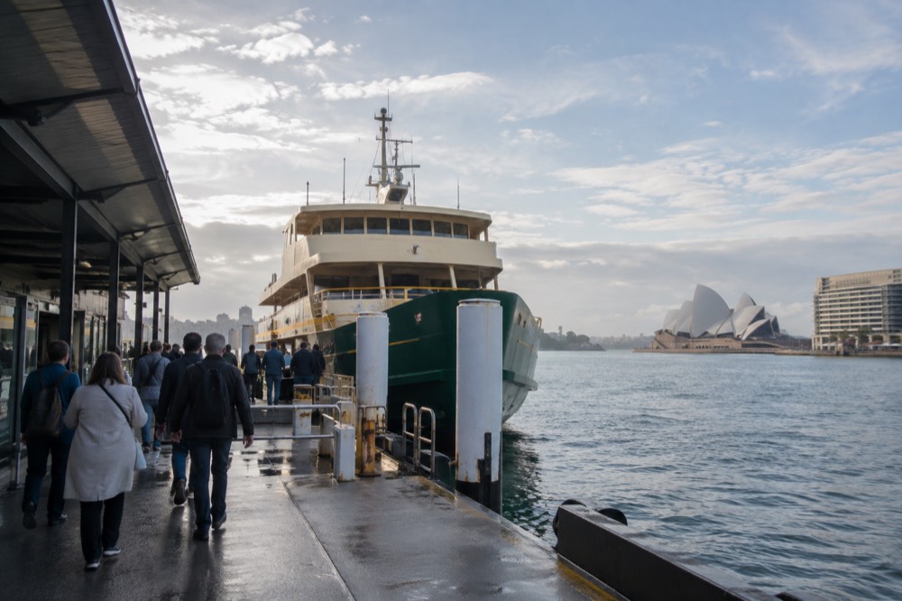 Passengers boarding a Sydney ferry at a Circular Quay wharf in the late afternoon