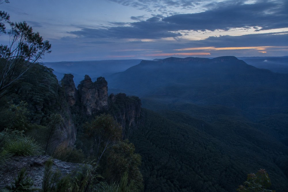Blue Mountains valley view with sandstone cliffs and eucalyptus forest haze