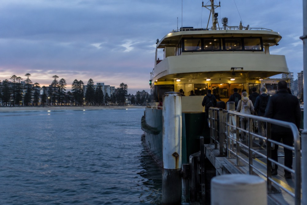 A Manly ferry at the wharf with passengers boarding at the gangway gates