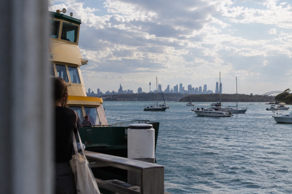 A ferry at Watsons Bay wharf with boats moored in the small bay