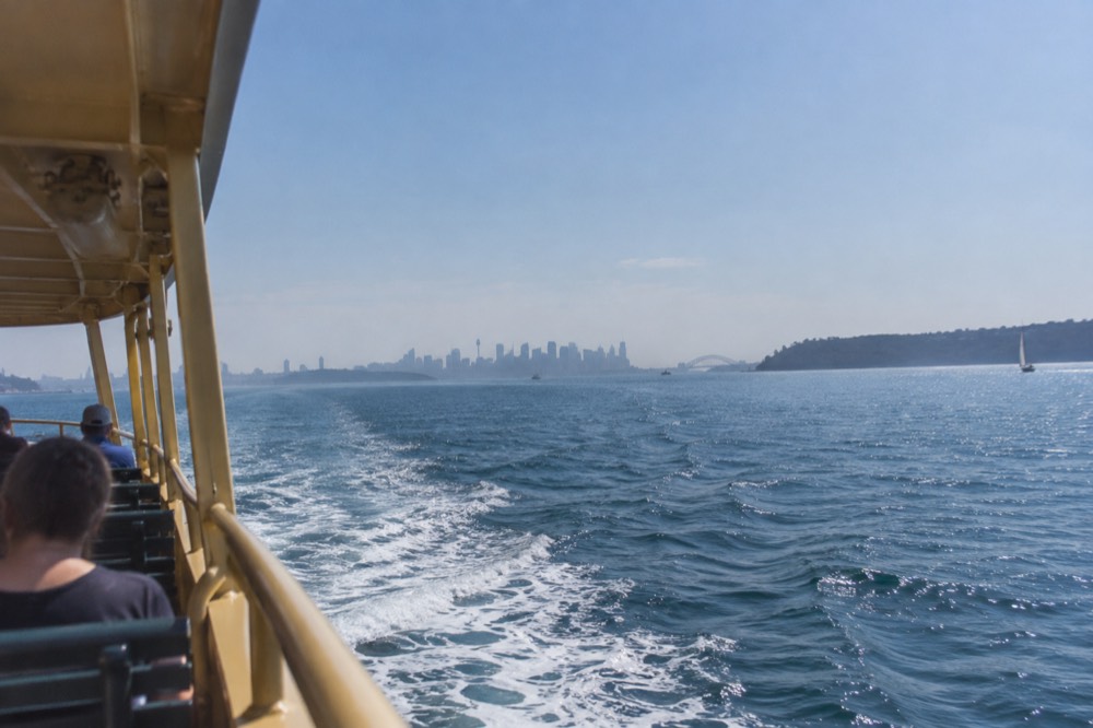 The Manly ferry crossing open harbour water toward the heads on a clear morning