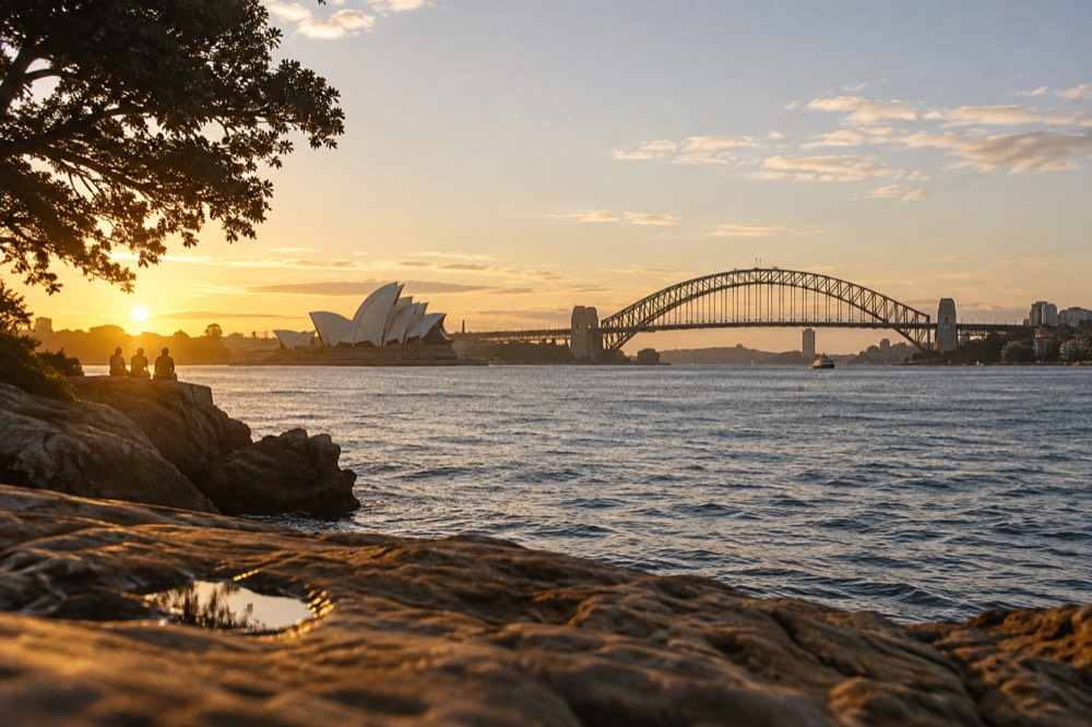 A sandstone point overlooking the Opera House and Harbour Bridge from across the water