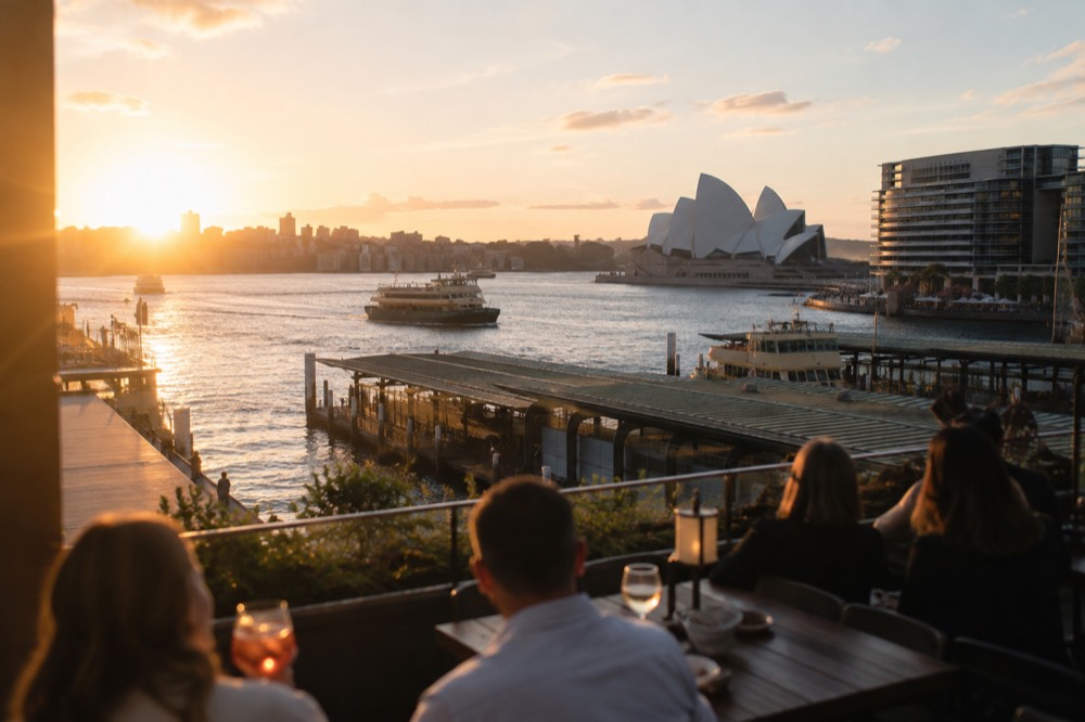 Evening breeze moving through an open rooftop terrace with city lights beyond
