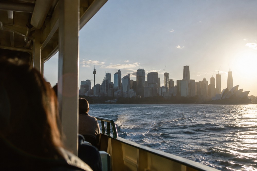 Ferry crossing Sydney Harbour with the city skyline behind it