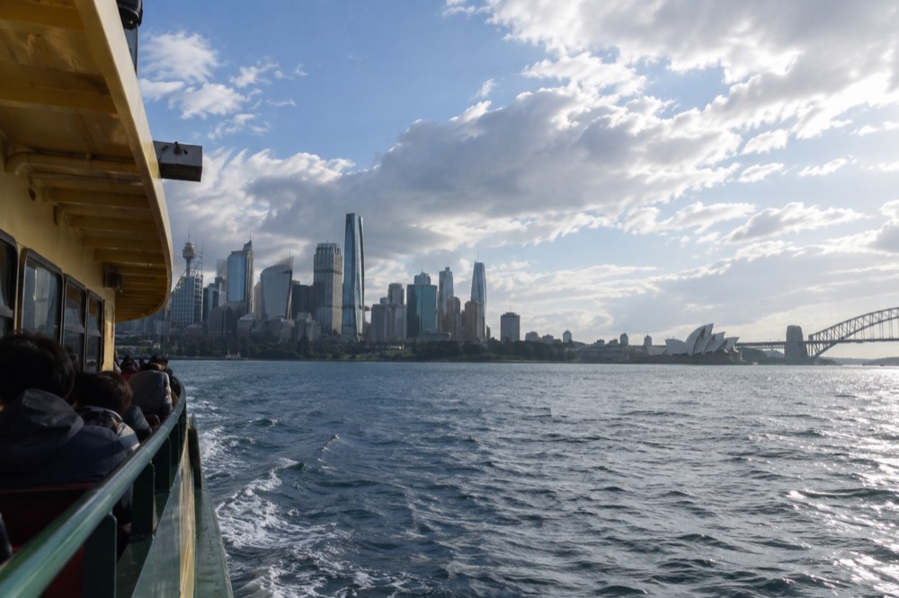 Ferry crossing Sydney Harbour with the skyline behind