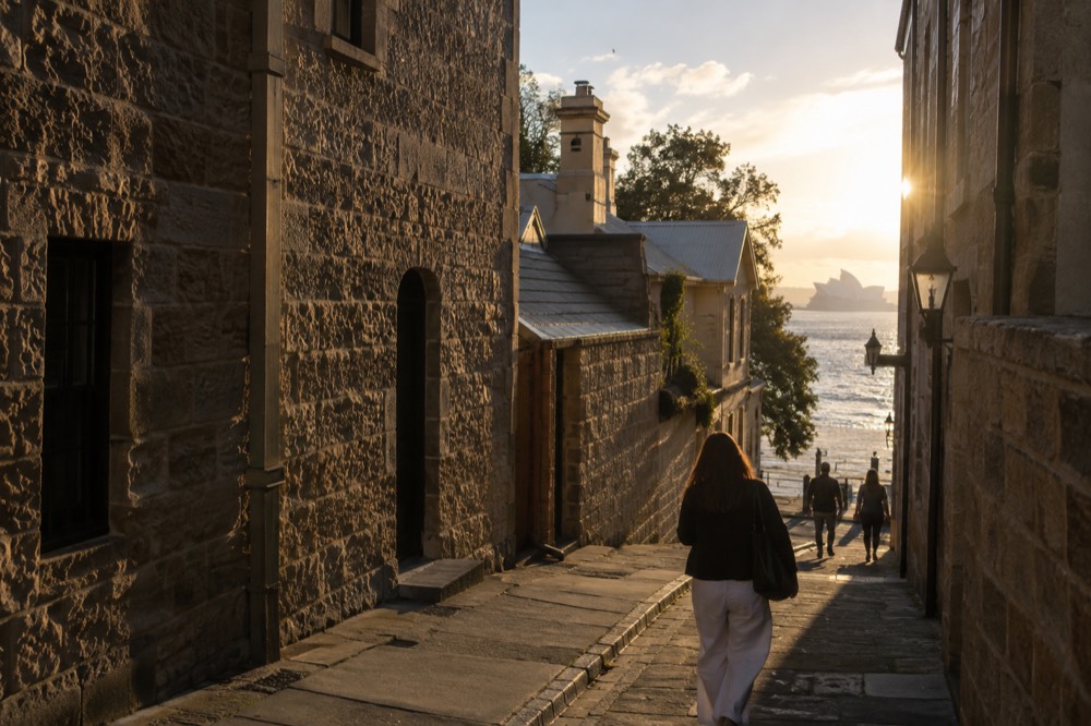 A narrow historic laneway between sandstone buildings in The Rocks