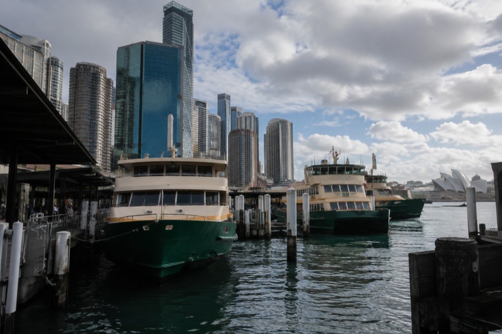 Ferries moored at Circular Quay with the city skyline behind them