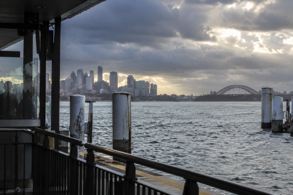 Rain clouds over the Sydney city skyline seen across the harbour