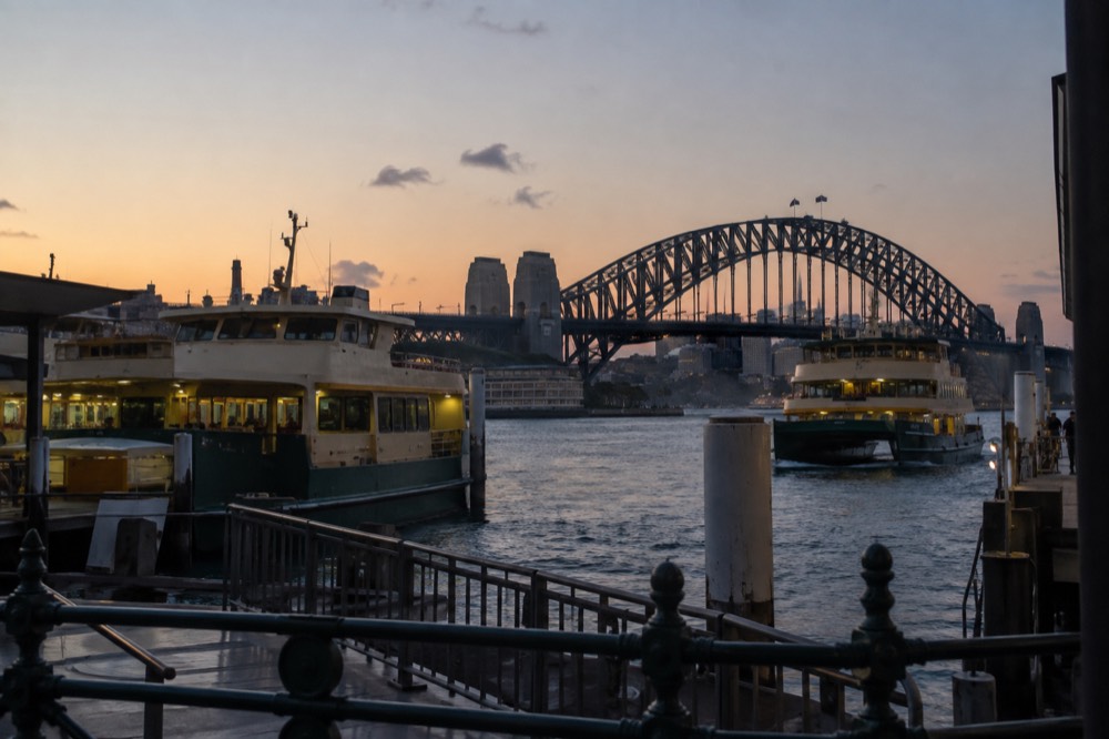 Ferries at Circular Quay wharves with the Sydney Harbour Bridge behind them
