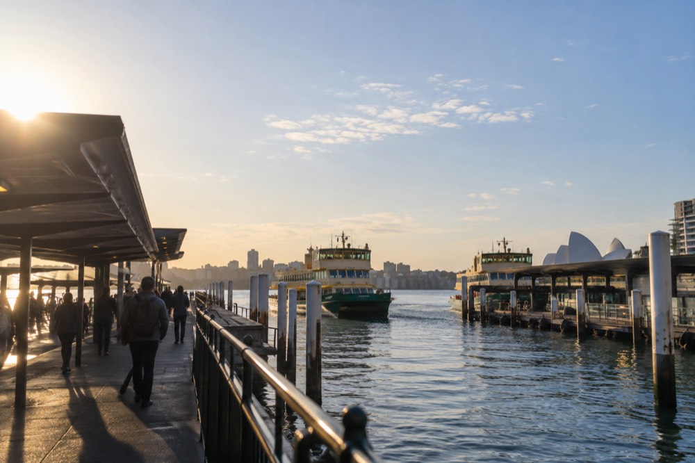 Commuters and ferries at Circular Quay wharves in morning light