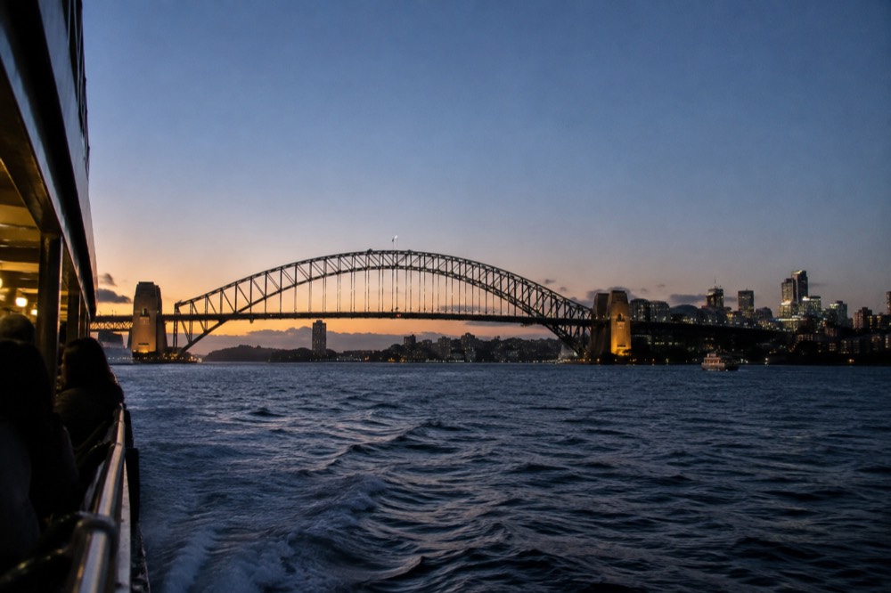 Winter sunset over Sydney Harbour Bridge and the city skyline seen from a ferry